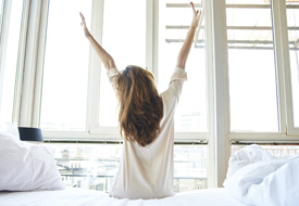 Woman Stretching in Bed